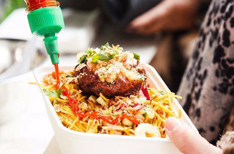 commercial barbecue street food in a carton with sauce