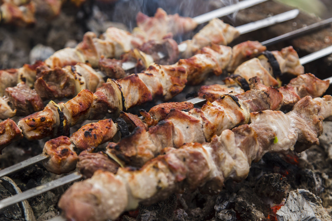 Kebabs and skewers on a commercial grill