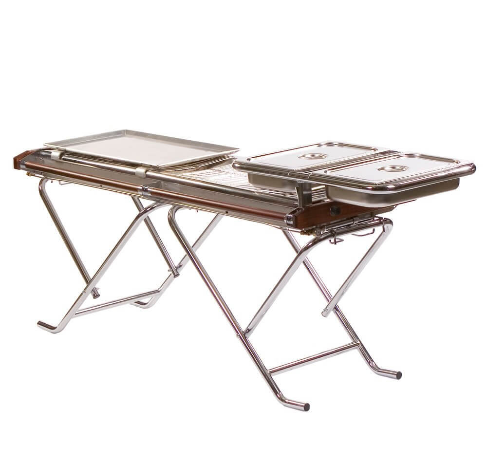 Caterer using pan support and griddle on Cinders BBQ grill