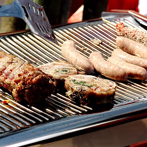 Outdoor grilling using Cinders BBQ at an event