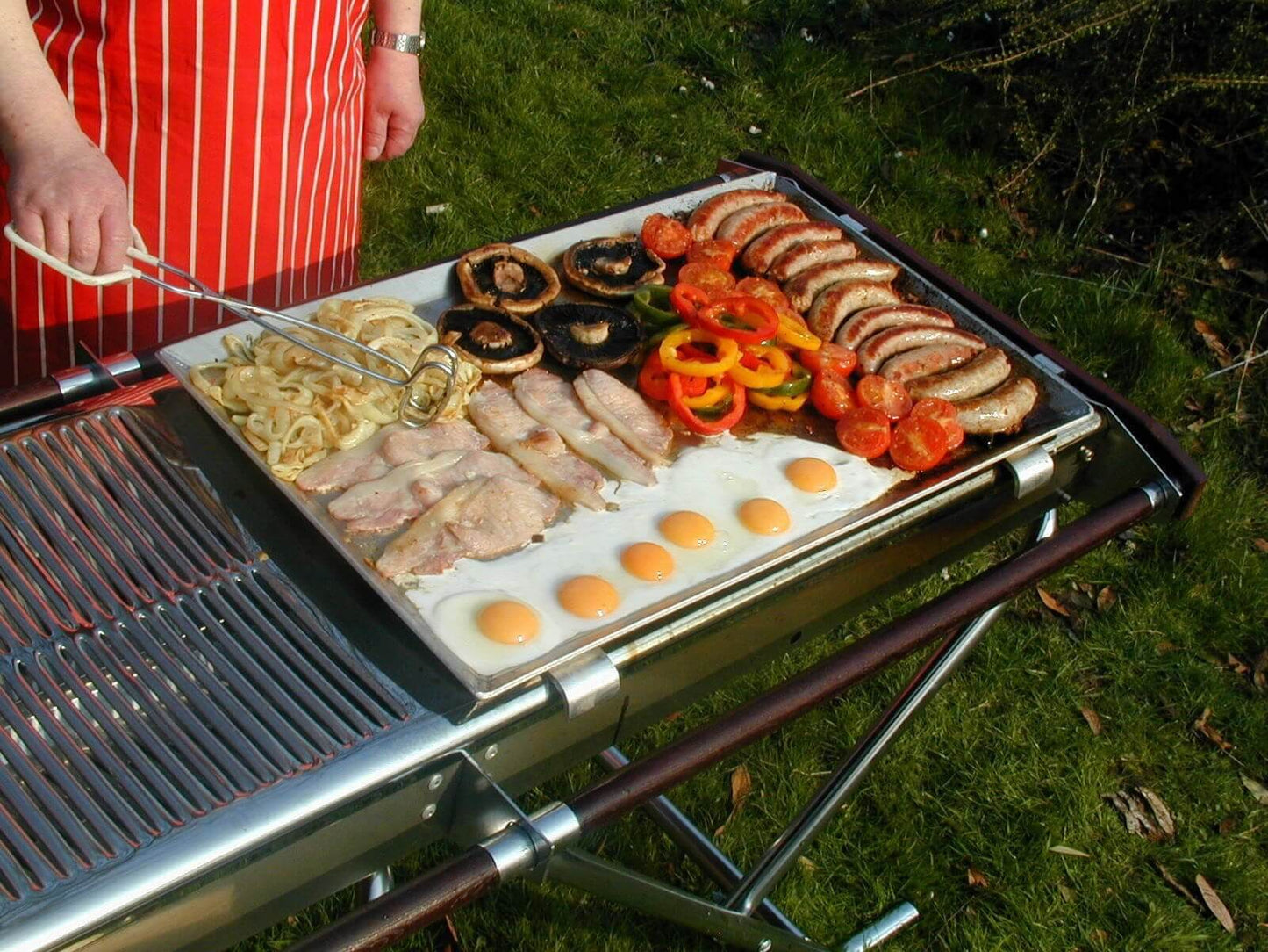 Flat griddle loaded with food on Cinders BBQ