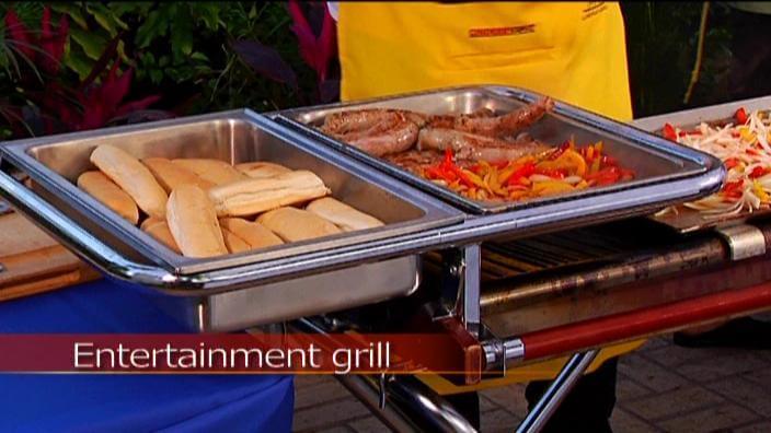 Pan support holding food on Cinders barbecue grill
